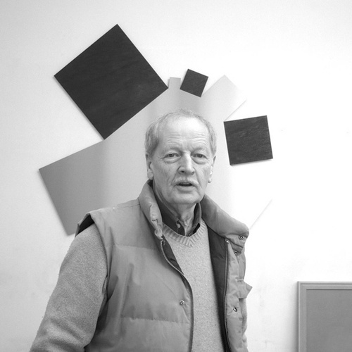 Photograph of Norman Dilworth in front of his work