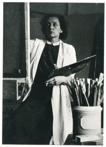 Photograph of Jessica Dismorr painting in her studio