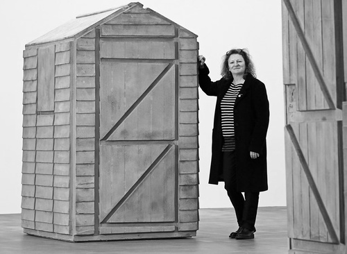 Photograph of Rachel Whiteread with one of the exhibits in her show 'Detached' at the Gagosian Gallery, London (2013).